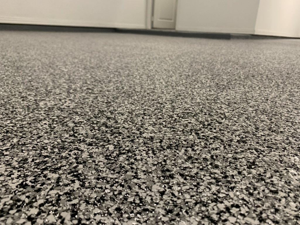 Epoxy flake garage floor with a black, gray, and white chip blend