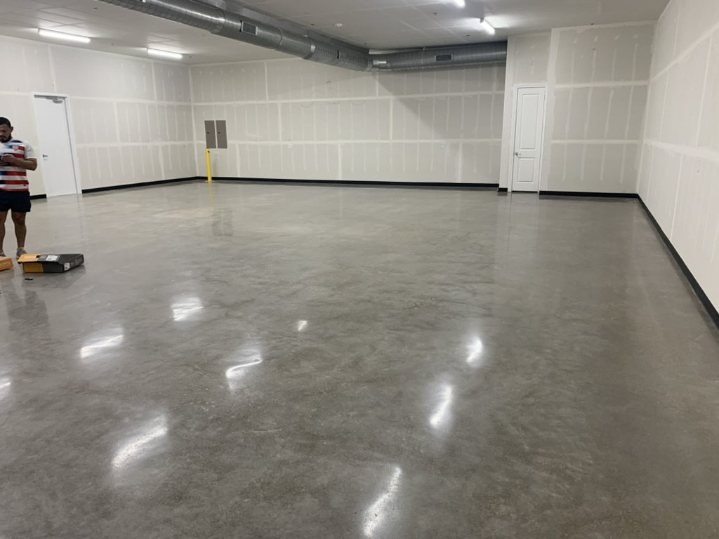 Ground and sealed concrete across a finished commercial buildout